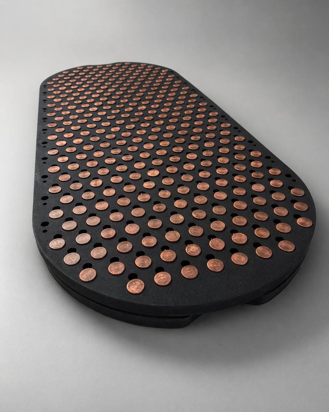 Steps Flex board — dramatic 3/4 view showing the full surface of tapered copper points